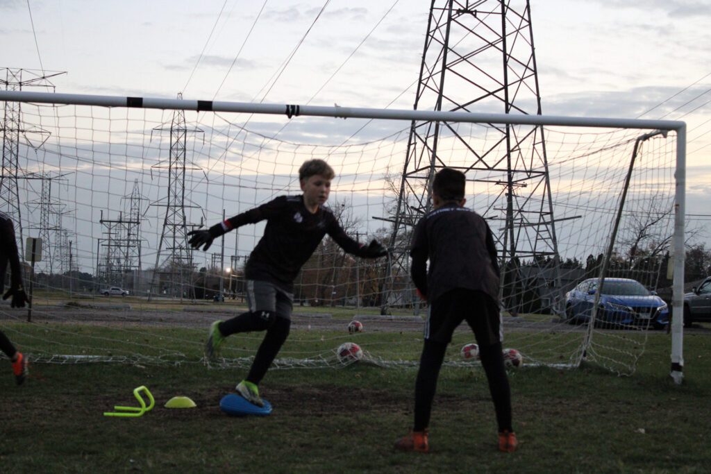 Goalkeeper training high diving saves with professional coaching at Instinct Save Academy